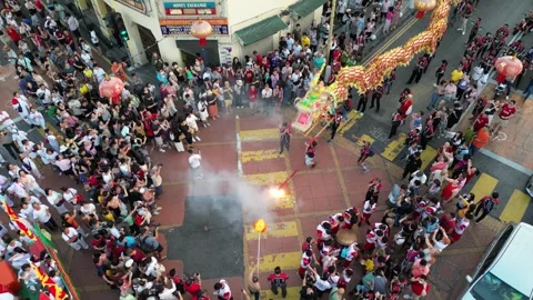 Energetic dragon dance draws large crowds along the city street. 스톡 동영상 317307676