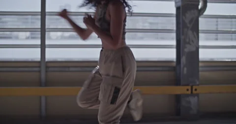 Energetic female dancer walking backwards Stock Footage 213644704