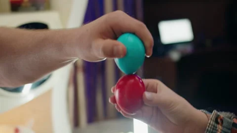 Energetic friends compete with painted eggs. Easter tradition of breaking eggs Stock Footage 330497970