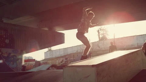 Energetic guys making jump tricks at skate park. Athletes jumping skateboard Stock Footage 171304568