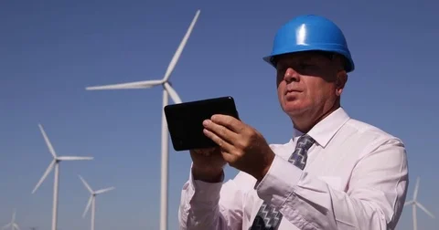 Energetic Industry Engineer Check Windmills Spin Speed Rotation Use Touch Pad Stock Footage 83655107