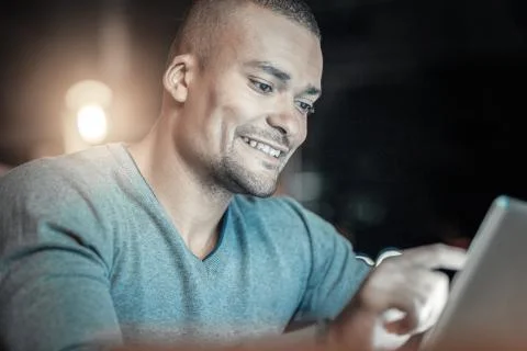 Energetic IT guy coding on tablet 스톡 사진