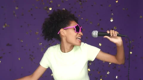 Energetic lady sing stage dance fall confetti isolated violet color background Stock Footage 165878873