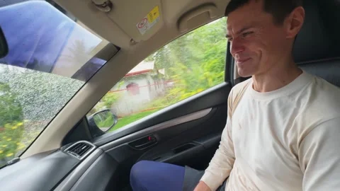 Energetic man talks in car gesturing enthusiastically Stock Footage 346944597
