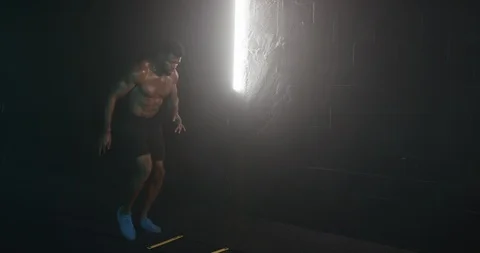 Energetic man working out with exercise equipment Stock Footage 116357221