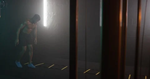 Energetic man working out with exercise equipment Stock Footage 116357273