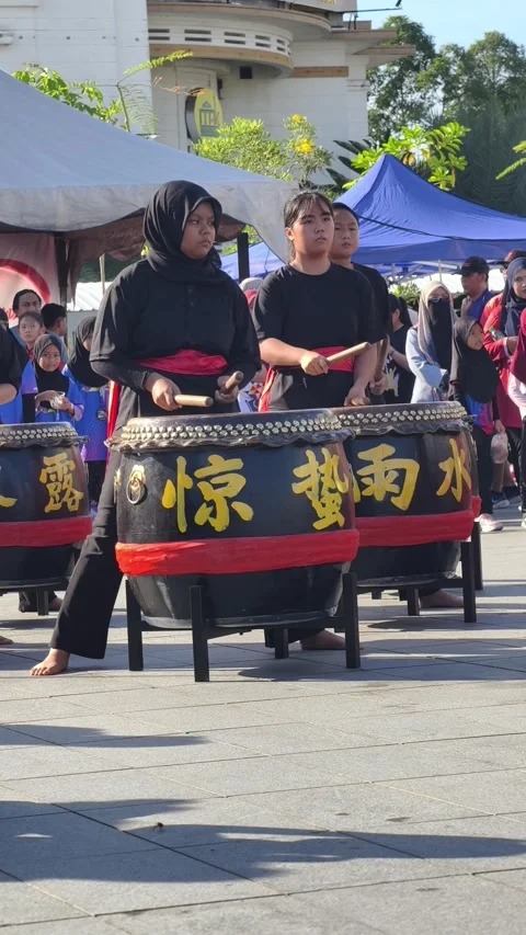 Energetic outdoor performance featuring a group of traditional Asian drummers Stock Footage 341800828