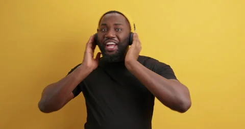 Energetic satisfied black guy with thick beard makes moves to rhythm of song Stock Footage 149912821
