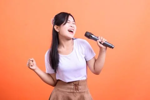 Energetic Singer with Microphone Stock Photos