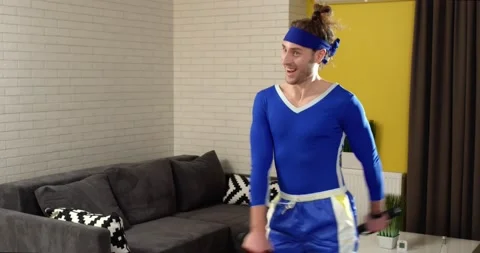 Energetic smiling Guy Training with Dumbbells actively doing Exercises at home Stock Footage 153683131