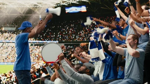 Energetic supporters beating percussion drum and blowing vuvuzelas Stock Footage 335678814