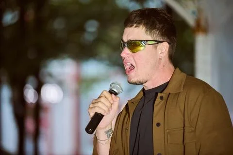 Energetic vocal performance in park setting Stock Photos