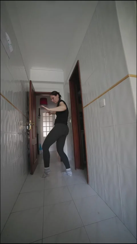 Energetic woman dancing in a corridor Stock Footage 304685526