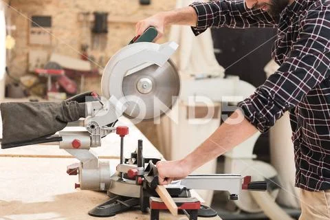 Energetic woodworker is toiling with pleasure Stock Photos