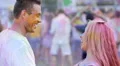 Energetic young couple covered in coloured powder dancing to music and smiling 4k or 4k+ Resolution