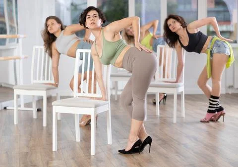 Energetic young female dancer practicing erotic movements of strip plastic near Stock Photos