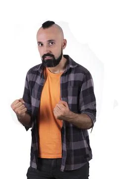 Energetic young man looking at camera and holding his fists Stock Photos
