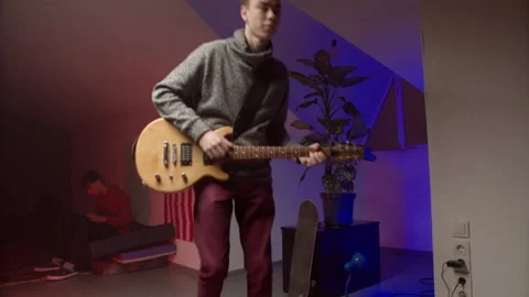 Energetic young man playing rock music on guitar Stock-Footage 147397971