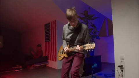 Energetic young man playing rock music on guitar Stock Footage 147398296