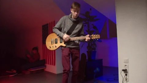 Energetic young man playing rock music on guitar Stock Footage 147399461