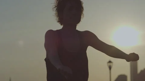Energizing dancer jumping workout at sunset in urban landscape Stock Footage 312622261