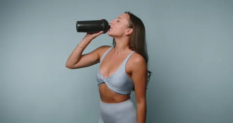 Energizing hydration routine for a fit and active lifestyle in a bright stu.. Видео 329113236