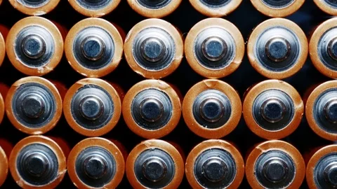 Energy abstract Background of Batteries. The top view of the AA-Size Battery Stock Footage 77362203