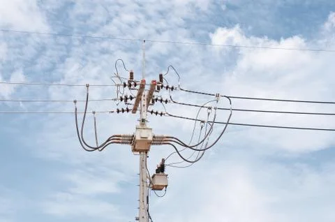 Energy and technology: electrical post by the road with power line cables, tr Stock Photos