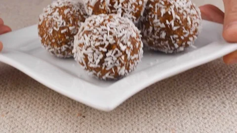 Energy Balls. Step by step recipe cooking. Hands pick up plate with energy Stock Footage 123293272