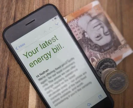 Energy bill. notification with bills and coins on wooden background Stock Photos