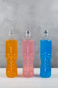 Energy drinks with different flavors on a light background. Stock Photos