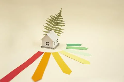 Energy efficiency rating chart, model miniature house and green fern leaf o.. Stock Photos