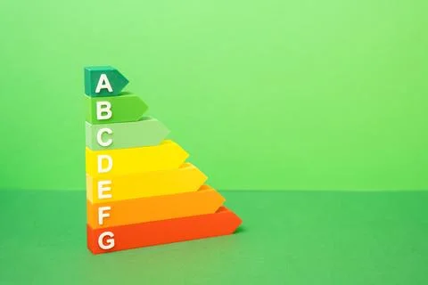 An energy efficiency scale on a green background. Concept of sustainability.. Stock Photos