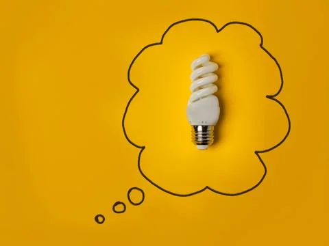 Energy efficient idea concept with a light bulb in a thought bubble Stock Photos