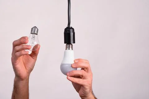 Energy efficient light bulb concept. Replace the incandescent bulb with an .. Stock Photos