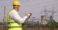 Energy-Engineer Maintains Electrical Equipment Writing Observations in Clipboard 4k or 4k+ Resolution