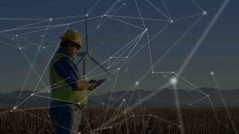 Energy engineer tapping tablet in field while network enveloping turbine Stock Footage 328647148