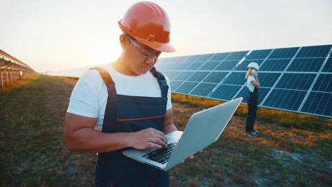 Energy expert asian workman using laptop controlling solar panel batteries Stock Footage 138722556