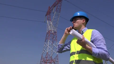 Energy power development blueprint plan electrician talk smart phone discussion Stock Footage
