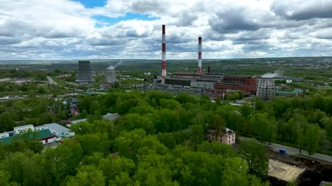 Energy production facility surrounded by greenery and cloudy sky Stock Footage 306300806