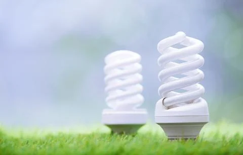 Energy saving bulbs in the grass Stock Photos
