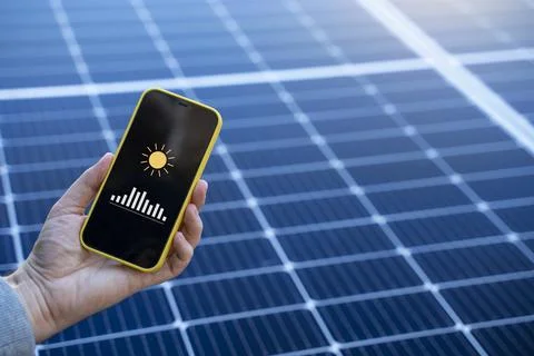 Energy saving concept with a light bulb and solar panels Stock Photos