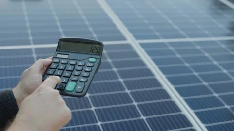 Energy saving concept with solar panels and a calculator Stock Footage 233966749