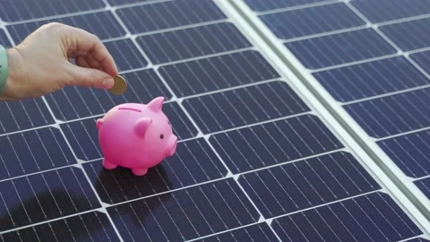 Energy saving concept with solar panels and a piggy bank Stock Footage 238736038