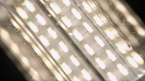 Energy-saving, eco-friendly, modern design Led lamp lights up on a black Stock Footage 130161503