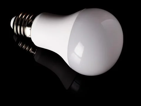 Energy saving LED light bulb isolated on a black background Stock Photos