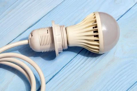 Energy saving light bulb and cable for installation against Stock Photos