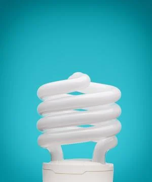 Energy saving light bulb on blue background Stock Photos