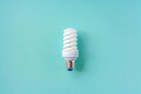 Energy saving light bulb on a blue background Stock Photos