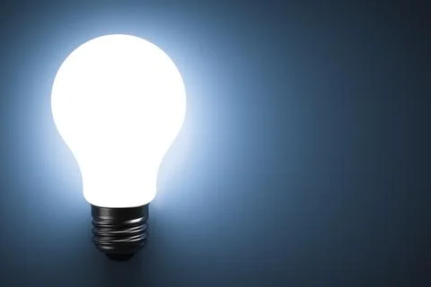 Energy saving light bulb glows. Copy space. Stock Photos